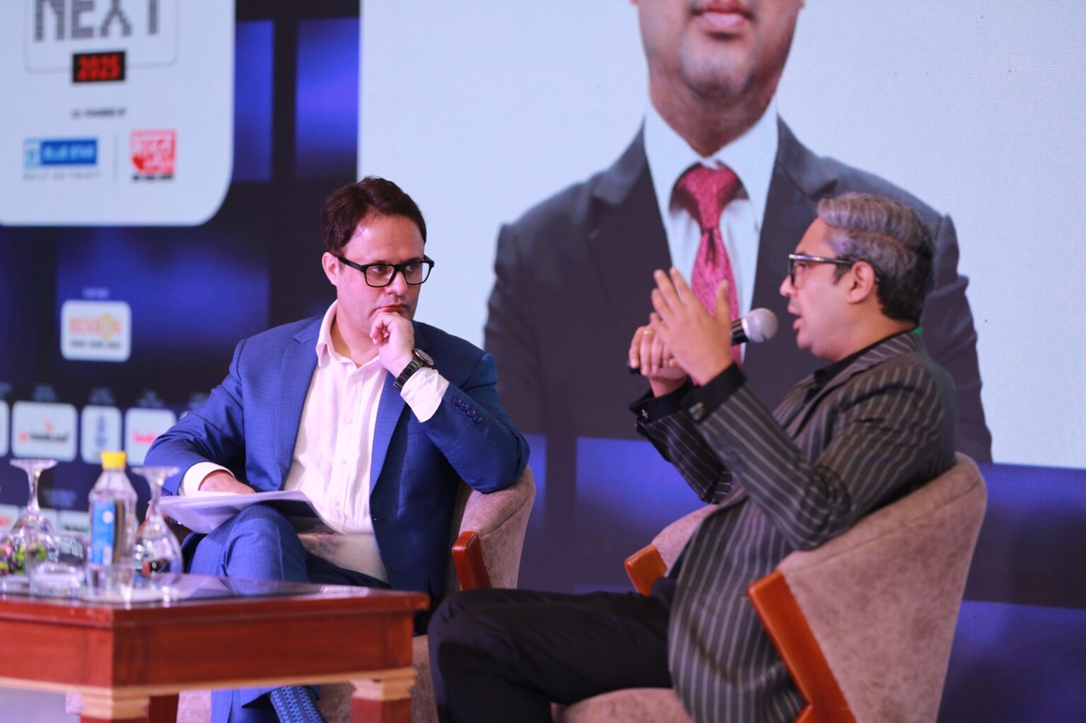 Ruhail Amin listening during an onstage interview