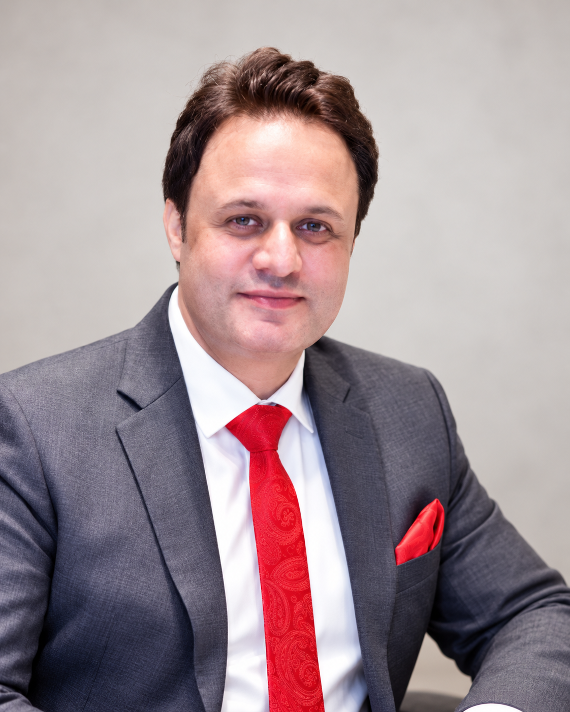 Ruhail Amin in a grey suit and red tie